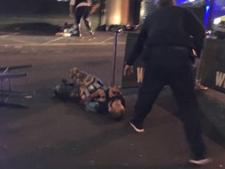 A man on the ground with canisters attached to his chest. Pic: Gabriele Sciotto