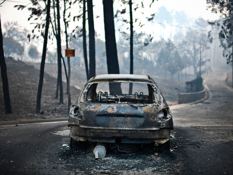 A burnt car on a road in Pedrogao, central Portugal