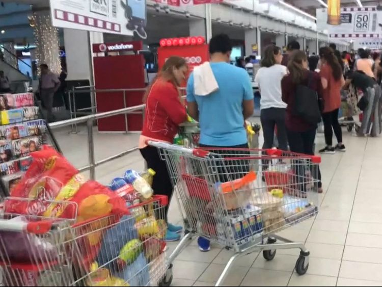 Customers queuing at a market