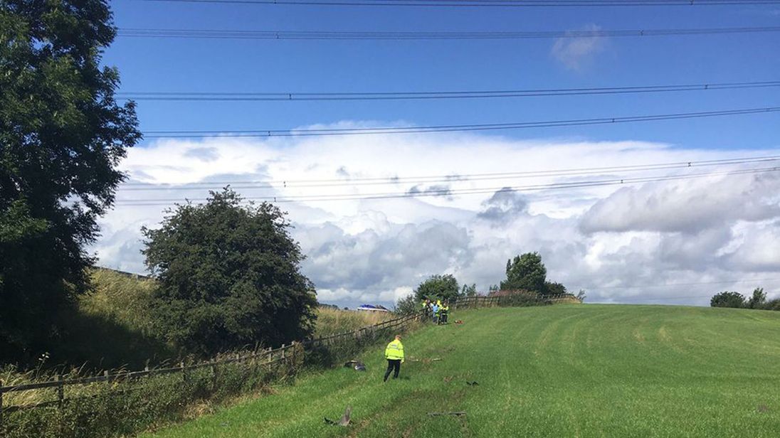 A Ferrari in a field after it crashed off the M1 motorway in South Yorkshire. Pic: South Yorkshire Police/Twitter
