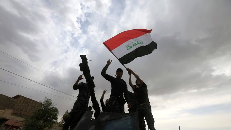 Members of the Emergency Response Division celebrate in Mosul's old city.