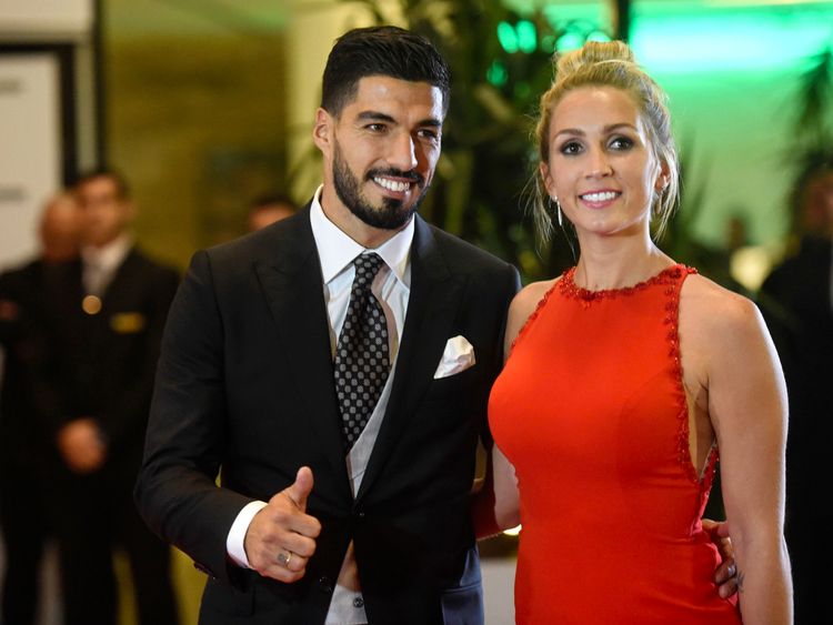 Uruguayan football player Luis Suarez and his wife Sofia Balbi pose on a red carpet during Barcelona&#39;s football star Lionel Messi and Antonella Roccuzzo wedding