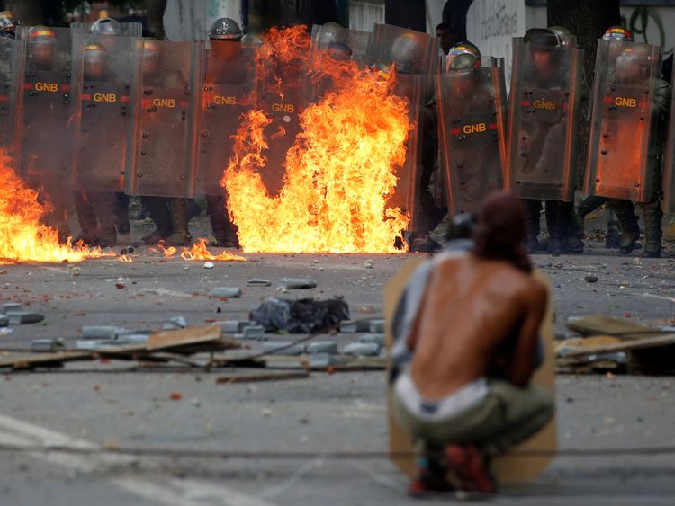 Demonstrators clash with riot security forces at a rally during a strike to protest against Venezuelan President Nicolas Maduro&#39;s government in Caracas