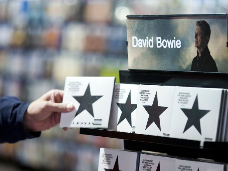 A customer picks up a copy of &#39;Blackstar&#39; the latest album by British musician David Bowie in a branch of HMV in central London on January 11, 2016. British music legend David Bowie has died at the age of 69 after a secret battle with cancer, drawing an outpouring of tributes for one of the most influential and innovative artists of his time. AFP PHOTO / JUSTIN TALLIS / AFP / JUSTIN TALLIS (Photo credit should read JUSTIN TALLIS/AFP/Getty Images)
