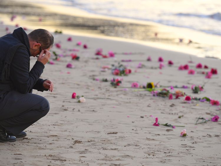 Flowers were scattered on Sydney's Freshwater beach during a vigil for Ms Damond