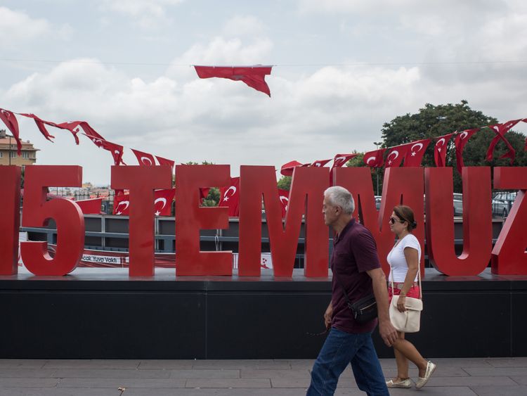 STANBUL, TURKEY - JULY 14: People are seen walking past a anniversary site setup to honour the victims of the July 15, 2016 coup attempt a day ahead of the first anniversary of the failed coup attempt on July 14, 2017 in Istanbul, Turkey. July 15, 2017 will mark the first anniversary of the failed coup attempt which saw 249 people die when military personnel attempted to over throw the government and President Recep Tayyip Erdogan. Extensive commemorations have been planned for the July 15 anniv