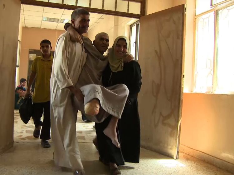 An man injured in the fighting is carried into the hospital