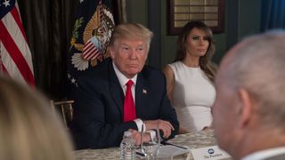 Donald Trump smiles before a meeting with administration officials in New Jersey