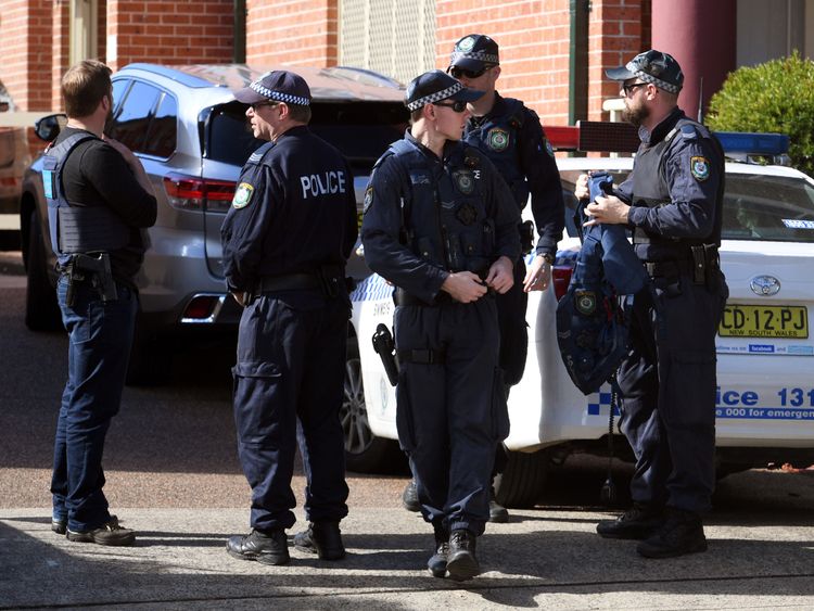Police emerge from a block of flats in the Sydney suburb of Lakemba on August 1, 2017, after counter-terrorism raids across the city at the weekend