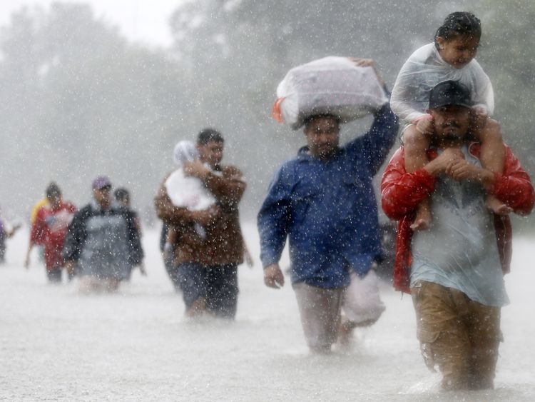 Texans wade through flood waters in Beaumont Place