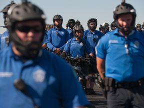Police block the road as protesters march through St Louis