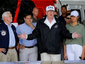 Donald Trump talks to reporters while receiving a briefing on Hurricane Irma relief efforts in Fort Myers