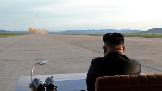 Kim Jong Un watches the launch of a Hwasong-12 missile
