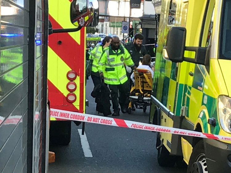 Emergency personnel attend to a person after an incident at Parsons Green underground station in London