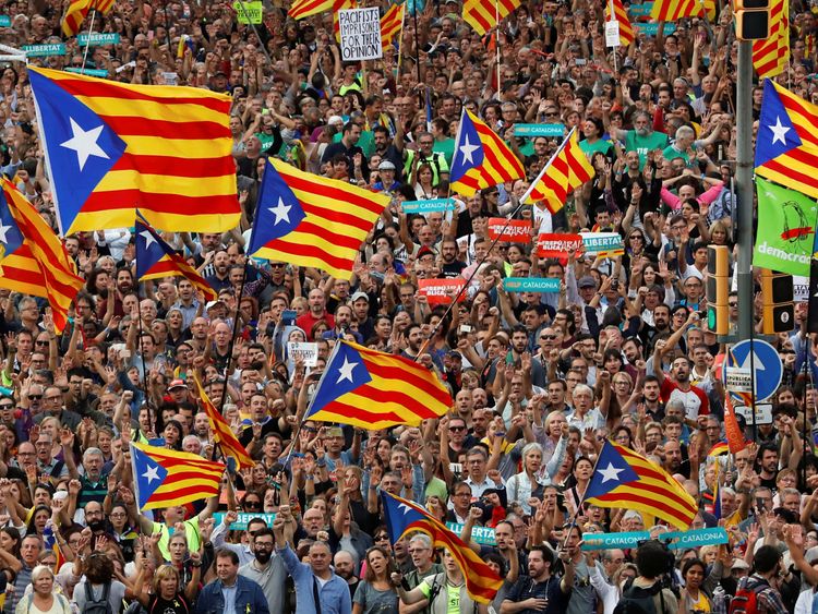 People wave Catalan separatist flags in Barcelona