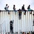 Caravan of asylum seekers arrive at US border wall
