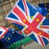 Anti-Brexit demonstrators protest with flags outside the Houses of Common on February 26, 2018 in London, England