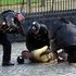 Armed police restrain a man inside the grounds of the Houses of Parliament
