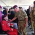 Prince Charles talks to former paratrooper Sandy Cortmann, 97, following his jump