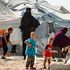 Women look after children at the Kurdish-run al-Hol camp for the displaced where families of Islamic State (IS) foreign fighters are held