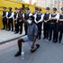 A man wearing a protective face mask kneels in front of police officers near the US Embassy, London, during the George Floyd protests