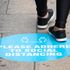 Social distancing sign outside a shop on the pavement in Edinburgh