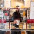 A member of staff hands over a coffee from behind a plastic protective screen at a branch of Pret a Manger in central London, as Prime Minister Boris Johnson said people who cannot work from home should be "actively encouraged" to return to their jobs.
