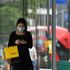 A shopper uses her phone as she wears a mask as a precaution against the transmission of the novel coronavirus as she walks past a shop window on Oxford Street in London on July 14, 2020. - Face masks will be compulsory in shops and supermarkets in England from next week, the government said on July 14, in a U-turn on previous policy. (Photo by JUSTIN TALLIS / AFP) (Photo by JUSTIN TALLIS/AFP via Getty Images)
