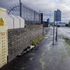 Car parts are pushed to the side of Frederick Road in Salford, Greater Manchester, after two men died and three people were admitted to hospital with serious injuries after a police chase ended with a road collision on Wednesday night.