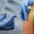 A woman in California is given a flu shot