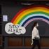 A woman wearing a face mask as a precaution walks past a Stay Alert, Save Lives rainbow sign in Soho. England is set to enforce a tough tier system once the lockdown ends on 2 December. (Photo by Vuk Valcic / SOPA Images/Sipa USA)