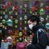 A man is seen walking past a festive window display in London during the pandemic