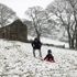 People play in the snow at The Roaches, Staffordshire