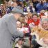 Queen Elizabeth II admires a corgi from the Manitoba Corgi Association as she meets the crowd at The Forks in Winnipeg, Manitoba, during her two week Golden Jubilee tour of Canada. *...Later, the Queen and her husband, the Duke of Edinburgh, were travelling on a water taxi when vessel's engine failed and a second water taxi, travelling behind the royal boat, had to be lashed to the stricken vessel to tow it to safety and the royals' destination.