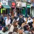 Police watch people eating and drinking at outside tables on Saturday evening in Soho, central London, following the further easing of lockdown restrictions in England. Picture date: Saturday April 24, 2021.
