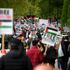 People hold placards and Palestine flags as they march to protest against Israeli attacks on Palestinians in Gaza, in London, Saturday, May 15, 2021.(AP Photo/Alberto Pezzali)