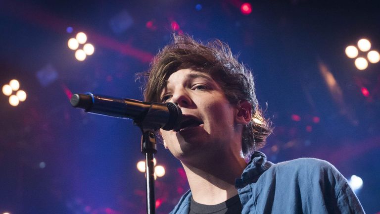 One Direction's Louis Tomlinson on stage