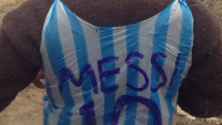 A boy fashions Messi's Argentinian football shirt from a plastic bag