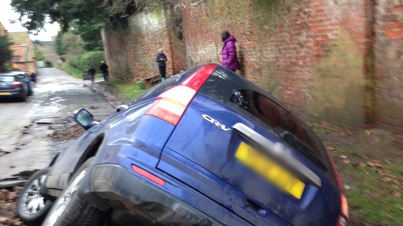 Car Slips Into Sinkhole After Water Main Bursts World News Sky News