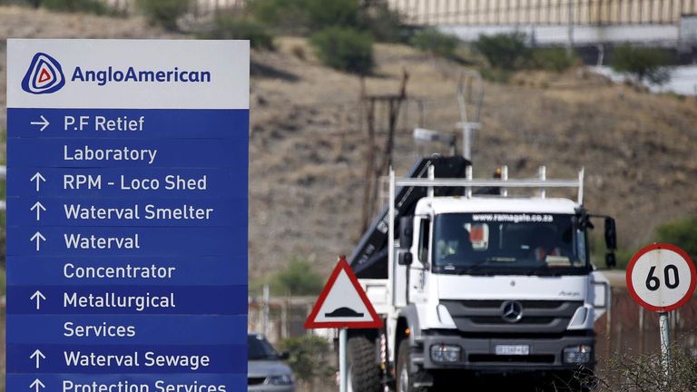 A truck drives past an AngloAmerican sign board at the company refinery, outside Rustenburg, northwest of Johannesburg