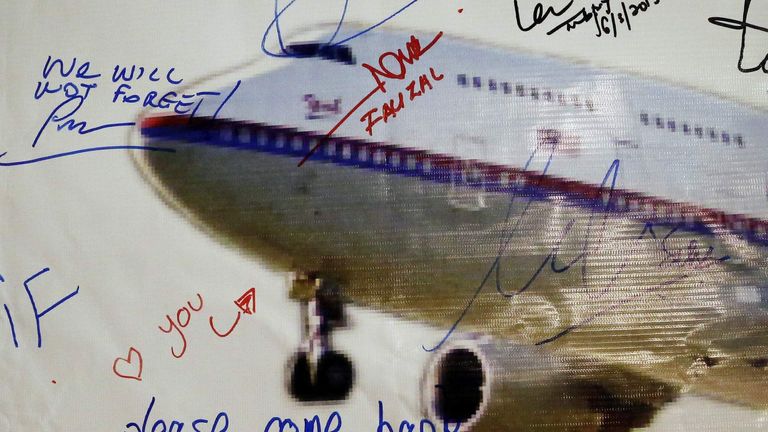 A message left on a board of remembrance by the wife of a passenger aboard missing Malaysia Airlines Flight MH370, at a vigil ahead of the one-year anniversary of its disappearance in Kuala Lumpur