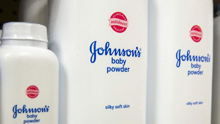 Bottles of Johnson & Johnson baby powder line a drugstore shelf in New York