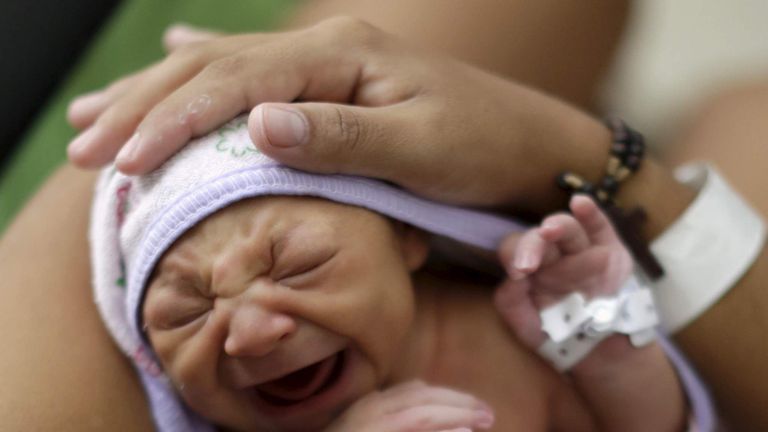 Sueli Maria holds her daughter Milena, who has microcephaly, at a hospital in Recife
