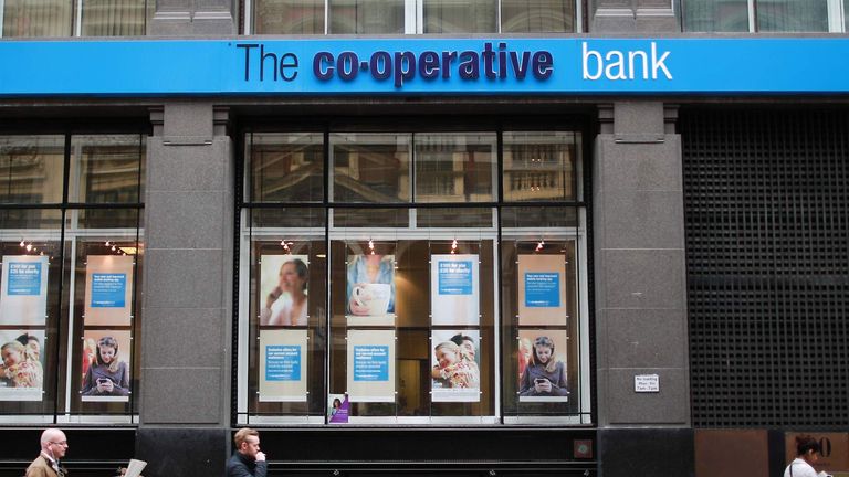 People walk past a branch of the Co-operative Bank