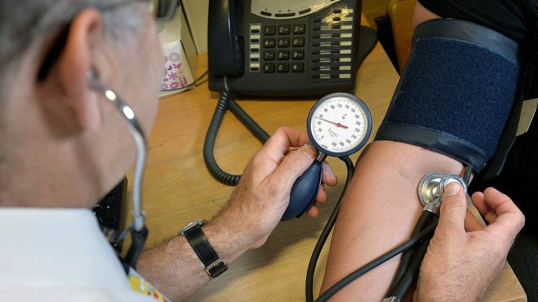 GP checking a patient's blood pressure