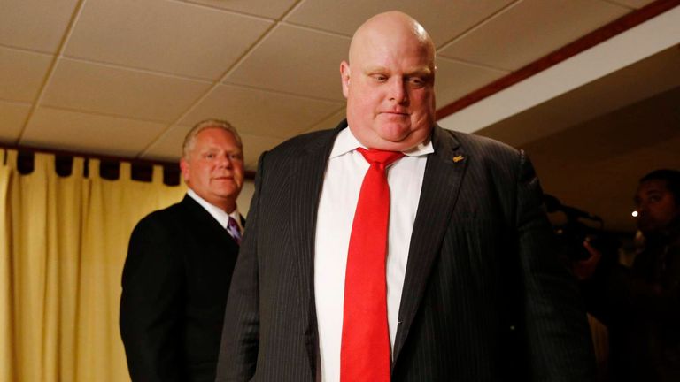 Mayor Rob Ford and his brother Doug leave the room after it was announced that Rob was elected as a city councillor and that Doug was stopped in his bid to become mayor in the municipal election in Toronto