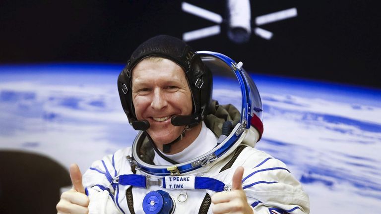 Crew member Timothy Peake of Britain gestures after donning a space suit at the Baikonur cosmodrome, Kazakhstan
