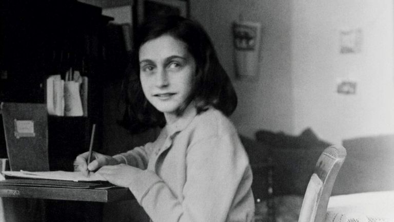 Hand out picture of Anne Frank at her desk in her house at the Merwedeplein in Amsterdam