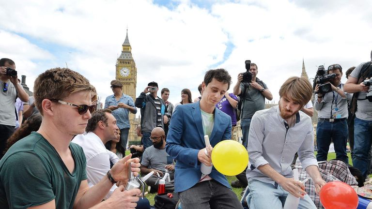 Protesters inhaled laughing gas outside Parliament to show their opposition to a proposed law on psychoactive substances.