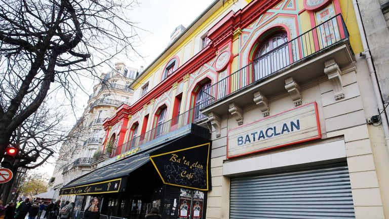 People walk past the Bataclan concert hall in Paris